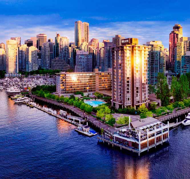 Bayshore Westin hotel with the Coal Harbour waterfront in the foreground and downtown Vancouver skyline behind