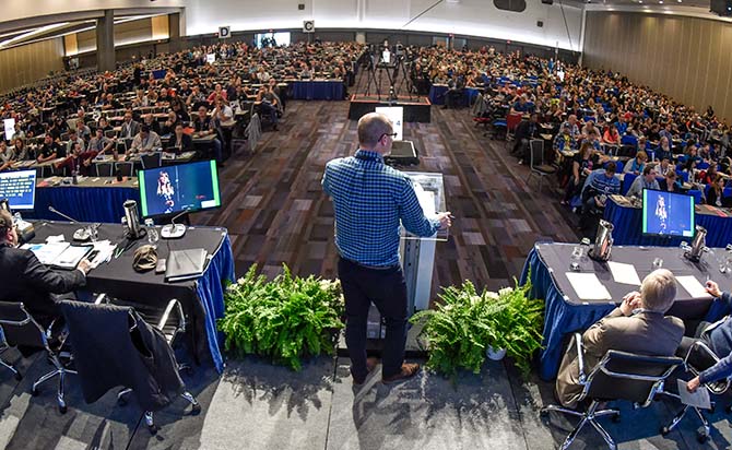 Laird Cronk seen from behind, speaking to the convention floor